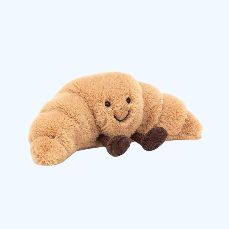 Cojín Peluche Croissant 33 cm – Suave, marrón claro, con carita sonriente
