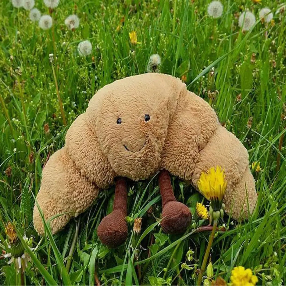 Cojín Peluche Croissant 33 cm – Suave, marrón claro, con carita sonriente